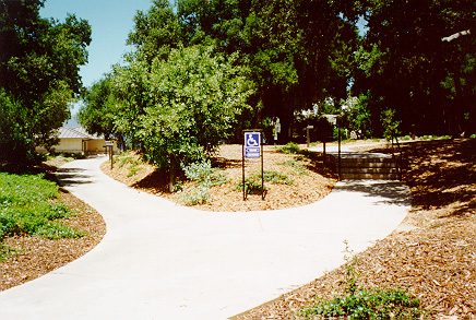 Wheel chair entrance path. South of main gate, near the new theater building.